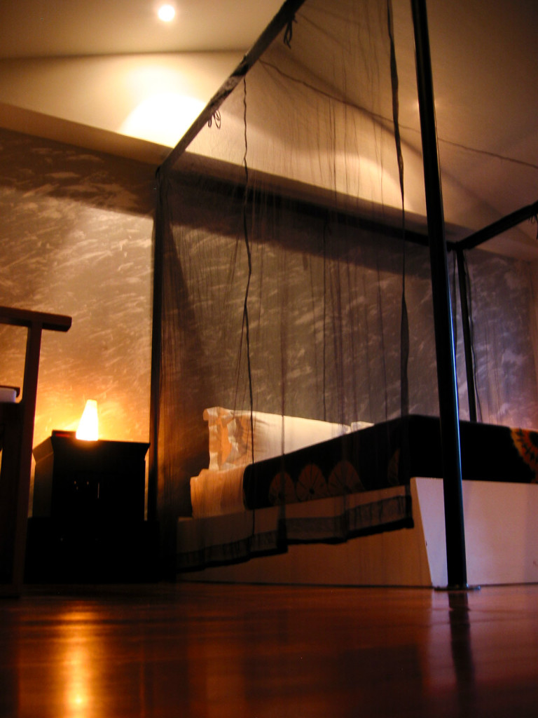 Inside the Deluxe Balcony room. The interior design reflects a traditional Thai belief by having black net around the bed, a symbol of a newlyweds in Northern Thailand. photo: the art resort.