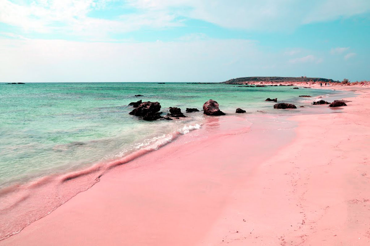 The sand of Elafonissi is in many places pinkish due to the thousands of broken seashells it contains. Photo via jessvactions.weebly.com